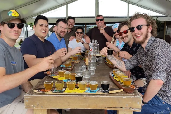 a group of people standing on top of a wooden table