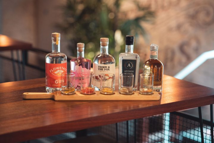 a glass of wine sitting on top of a wooden table
