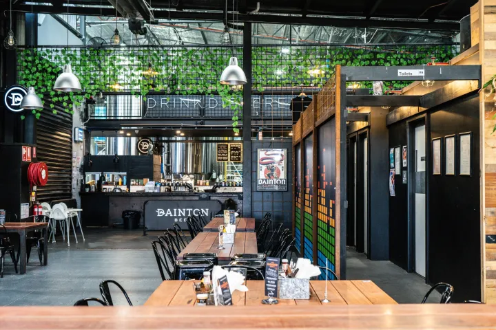 a group of people sitting at a table in front of a building