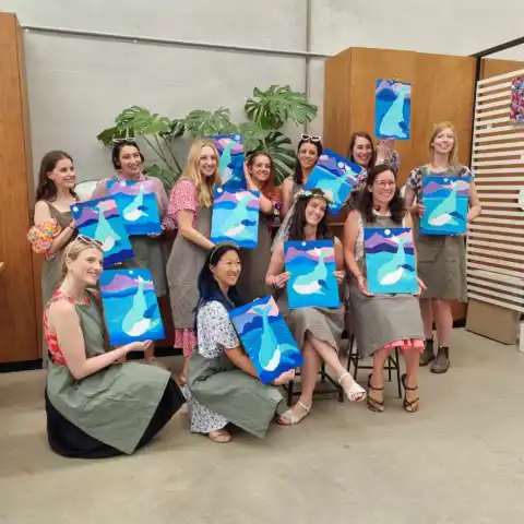 a group of young children sitting next to a building