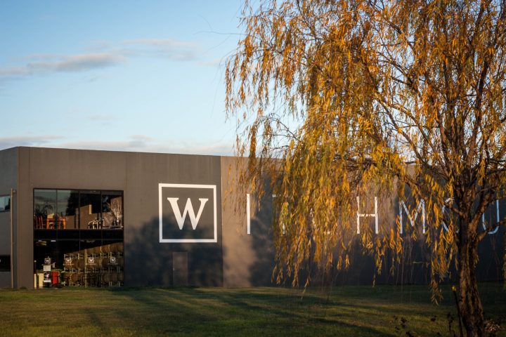 a sign in front of a tree
