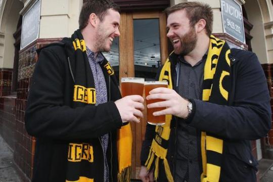 a man wearing a suit and tie holding his hand up