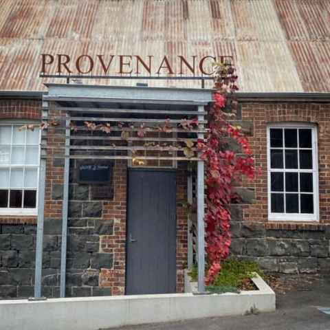 a bench in front of a brick building